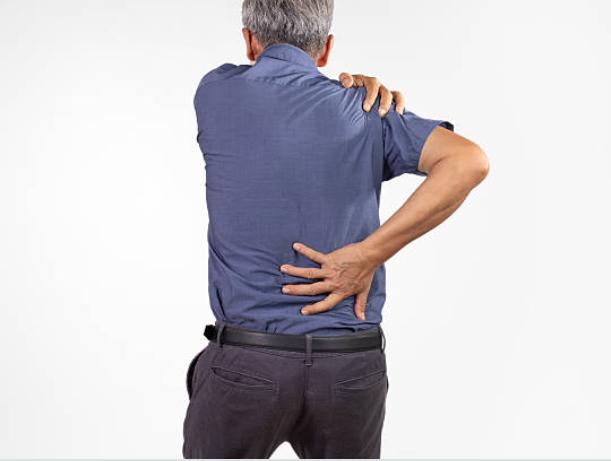 Man holding his shoulder and back in pain from a tendon injury